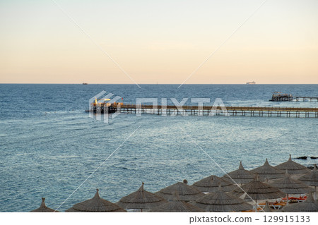 Calm waters and scenic pier at sunset in Egypts coastal region 129915133