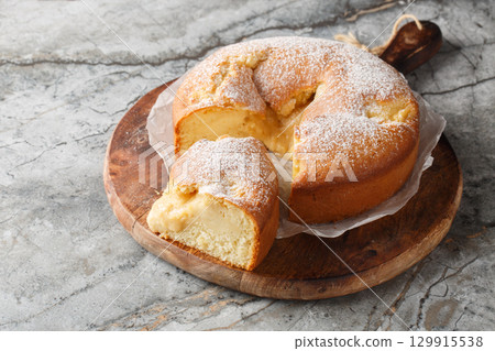 Italian Custard Cake or Torta Nua is a quintessentially dessert known for its minimalistic appearance and decadent flavor closeup on the wooden board. Horizontal 129915538