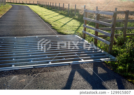 Cattle Grid at the Entrance to a Farm Access Road on a Summer Evening Cattle Grid at the Entrance to a Farm Access Road on a Summer Evening 129915807