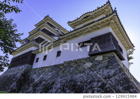 The beautiful castle tower of Ozu Castle in Ehime Prefecture stands tall above the stone walls The beautiful castle tower of Ozu Castle in Ehime Prefecture stands tall above the stone walls 129915984