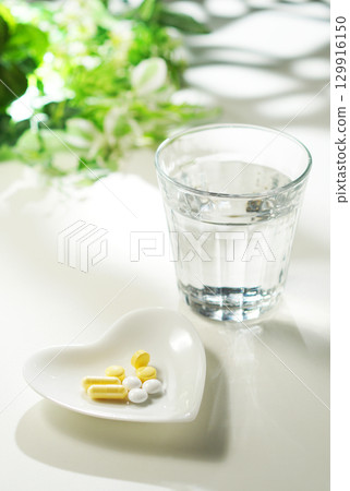 藥片和膠囊以及一杯礦泉水 藥片和膠囊以及一杯礦泉水 129916150