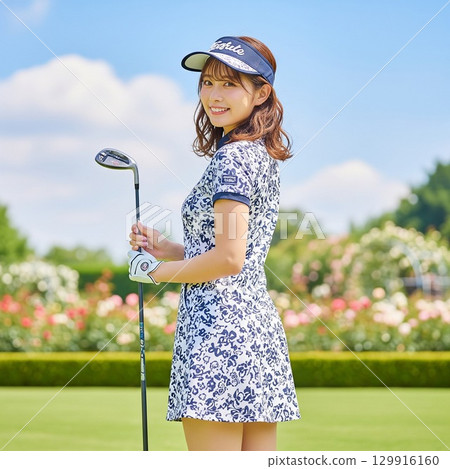 A woman in white and navy floral golf wear posing for a golf swing, back view, turning around A woman in white and navy floral golf wear posing for a golf swing, back view, turning around 129916160