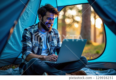 Smiling man working in tent 129916231