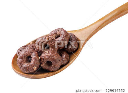 Chocolate corn rings in a wooden spoon on a white background. Isolated Chocolate corn rings in a wooden spoon on a white background. Isolated 129916352
