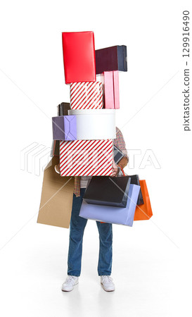 Man overloaded with mountain of shopping boxes and paper bags Man overloaded with mountain of shopping boxes and paper bags 129916490