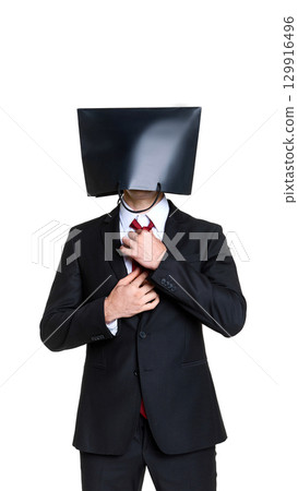 Businessman with black shopping bag on head adjusting tie with confident gesture 129916496