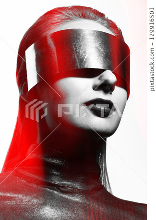 Abstract woman studio portrait with metallic glasses or helmet covering her eyes in RGB color split effect style 129916501