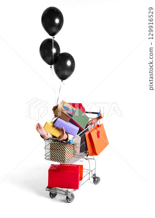 Shopping cart filled with colorful gift boxes and balloons on white background Shopping cart filled with colorful gift boxes and balloons on white background 129916529