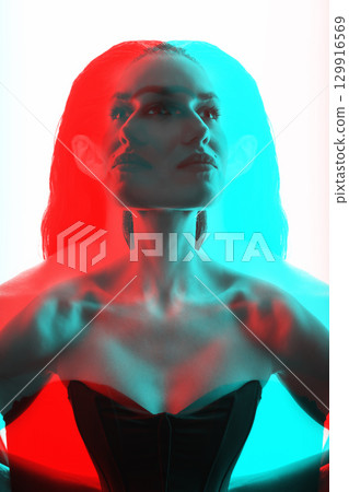 Beautiful woman with corset and wet hair studio portrait in RGB color split effect style Beautiful woman with corset and wet hair studio portrait in RGB color split effect style 129916569