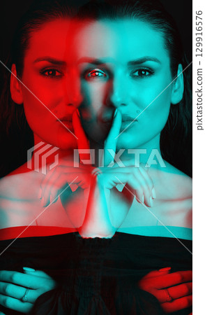 Beautiful woman with dark hair and blouse close-up studio portrait in RGB color split effect style Beautiful woman with dark hair and blouse close-up studio portrait in RGB color split effect style 129916576