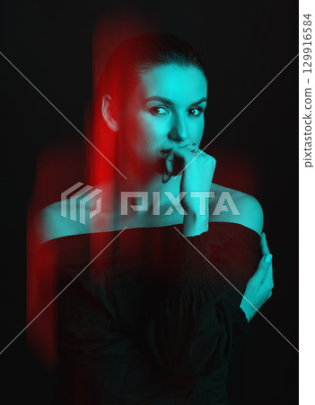 Beautiful woman with dark hair and blouse close-up studio portrait in RGB color split effect style 129916584