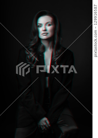 Beautiful woman with dark suit and wavy hair studio portrait in RGB color split effect style 129916587