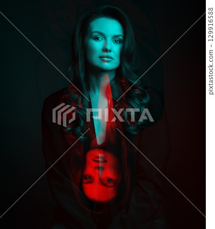 Beautiful woman with dark suit and wavy hair studio portrait in RGB color split effect style 129916588
