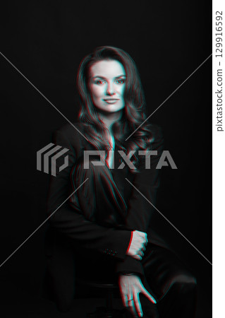 Beautiful woman with dark suit and wavy hair studio portrait in RGB color split effect style Beautiful woman with dark suit and wavy hair studio portrait in RGB color split effect style 129916592