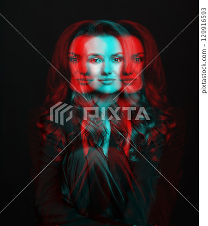 Beautiful woman with dark suit and wavy hair studio portrait in RGB color split effect style 129916593