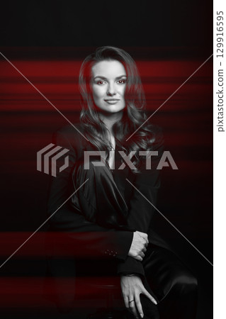 Beautiful woman with dark suit and wavy hair studio portrait in RGB color split effect style 129916595