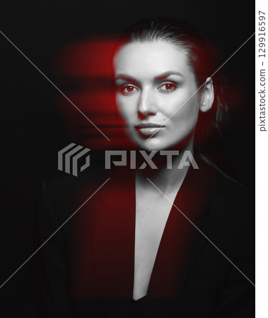 Beautiful woman with dark suit and wet hair studio portrait in RGB color channel split effect style 129916597