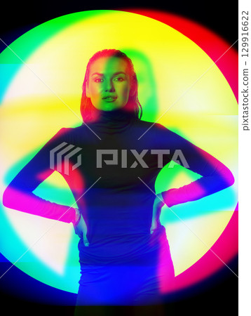 Woman with black turtle neck sweater, tight trousers and wet hair style studio portrait in RGB color split effect 129916622