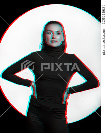 Woman with black turtle neck sweater, tight trousers and wet hair style studio portrait in RGB color split effect 129916623