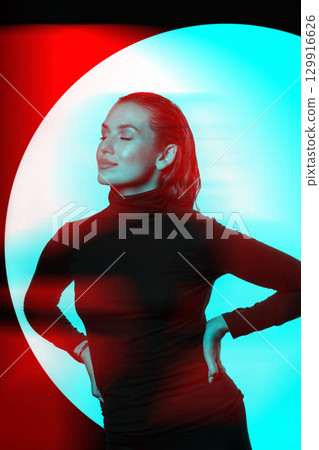Woman with black turtle neck sweater, tight trousers and wet hair style studio portrait in RGB color split effect 129916626