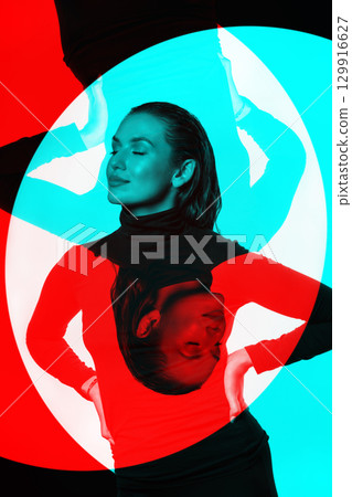 Woman with black turtle neck sweater, tight trousers and wet hair style studio portrait in RGB color split effect 129916627