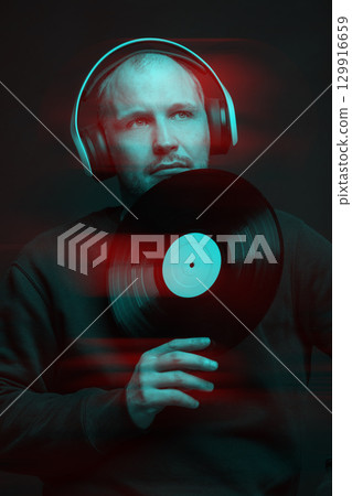 Man with sweatshirt headphones and LP vinyl studio portrait in glitch and RGB color split effect style 129916659