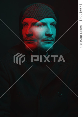 Serious man with black winter coat and winter hat studio portrait in glitch and RGB color split effect style Serious man with black winter coat and winter hat studio portrait in glitch and RGB color split effect style 129916671