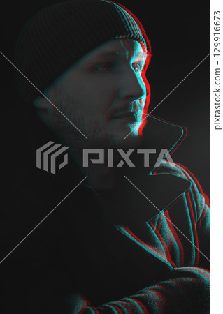 Serious man with black winter coat and winter hat studio portrait in glitch and RGB color split effect style Serious man with black winter coat and winter hat studio portrait in glitch and RGB color split effect style 129916673