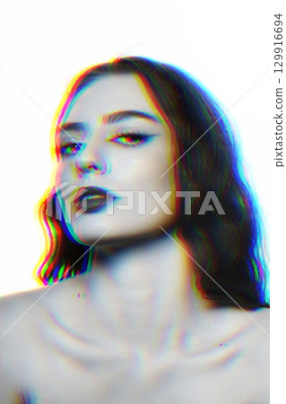 Beautiful woman with wavy long hair and makeup studio portrait in RGB color split effect style 129916694