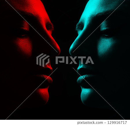 Beautiful woman face silhouette portrait illuminated with light in RGB color split effect style and dark background 129916717