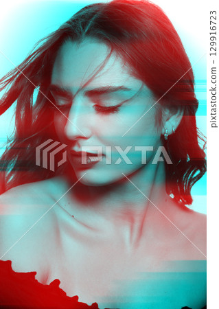 Beautiful woman with long wavy flying hair sensual studio portrait in RGB color split effect style 129916723