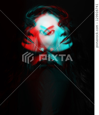 Woman with long wavy hair sensual studio portrait in RGB color split effect style 129916741