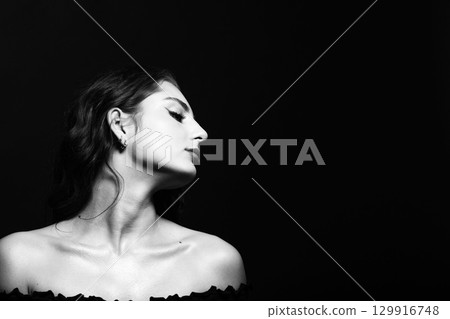 Beautiful brunette woman with wavy long hair and make-up close-up studio portrait Beautiful brunette woman with wavy long hair and make-up close-up studio portrait 129916748