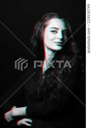 Woman with long wavy hair sensual studio portrait in RGB color split effect style 129916749