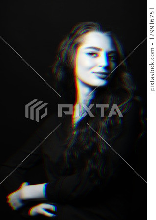 Woman with long wavy hair sensual studio portrait in RGB color split effect style 129916751