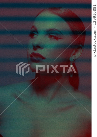 Abstract beautiful woman studio portrait with classic hairstyle and round golden earrings 129916881