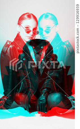 Woman studio portrait with black punk leather jacket, sunglasses and without bra in RGB color split effect style Woman studio portrait with black punk leather jacket, sunglasses and without bra in RGB color split effect style 129916939