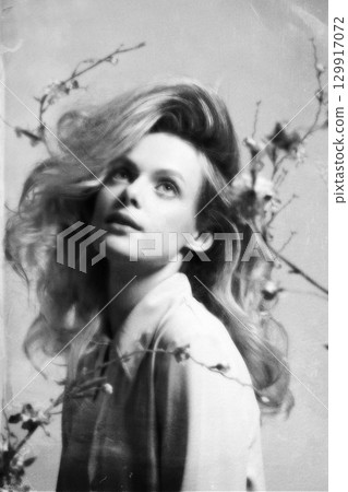 Beautiful woman with big wavy hair and flowers studio portrait in retro vintage style Beautiful woman with big wavy hair and flowers studio portrait in retro vintage style 129917072