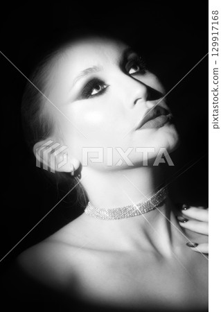 Beautiful woman portrait illuminated with bright studio light 129917168