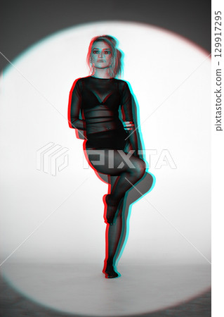 Beautiful woman with tight black clothes studio portrait in RGB colors split effect style 129917295