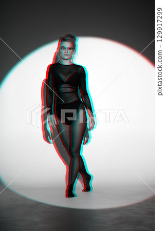 Beautiful woman with tight black clothes studio portrait in RGB colors split effect style 129917299