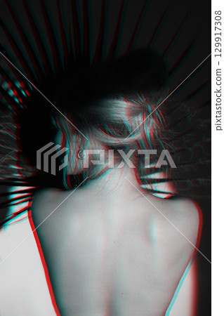 Beautiful woman with naked back and palm leaf studio portrait in RGB color split effect style 129917308