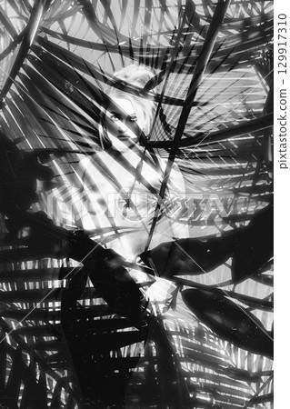 Beautiful woman with shining corset standing in jungles abstract collage portrait 129917310