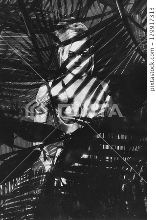 Beautiful woman with shining corset standing in jungles abstract collage portrait 129917313