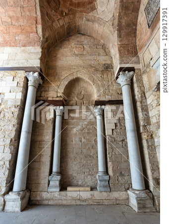Architectural details: Columns, stone walls, and arched niche in the Mosque of al-Zahir Baybars, Cairo, Egypt Architectural details: Columns, stone walls, and arched niche in the Mosque of al-Zahir Baybars, Cairo, Egypt 129917391