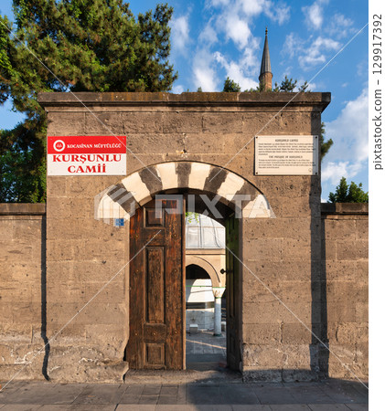 Arched stone entrance and wooden gate of Kursunlu Mosque, or Kursunlu Camii, Kayseri, Turkey 129917392