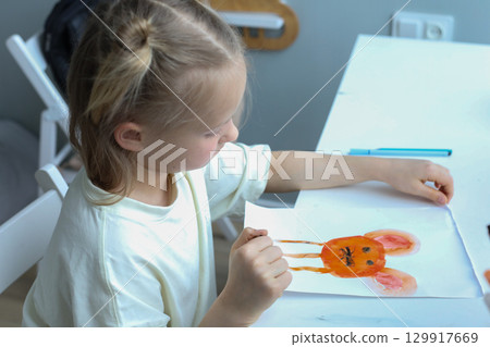 Close-up portrait of young child painting at home Close-up portrait of young child painting at home 129917669