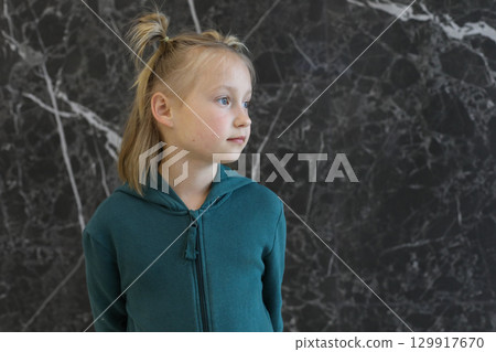 Profile of blond child girl in lounge. Young girl 6 years old portrait Profile of blond child girl in lounge. Young girl 6 years old portrait 129917670