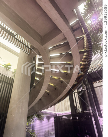 Stylish spiral staircase with contemporary design and soft lighting in a modern interior. High quality photo 129918589