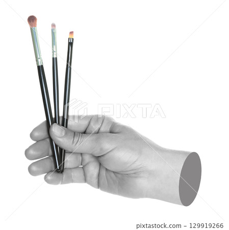 Woman hand holds black cosmetics brushes, isolated on transparent background, cosmetics and visage concept. Contemporary art Woman hand holds black cosmetics brushes, isolated on transparent background, cosmetics and visage concept. Contemporary art 129919266